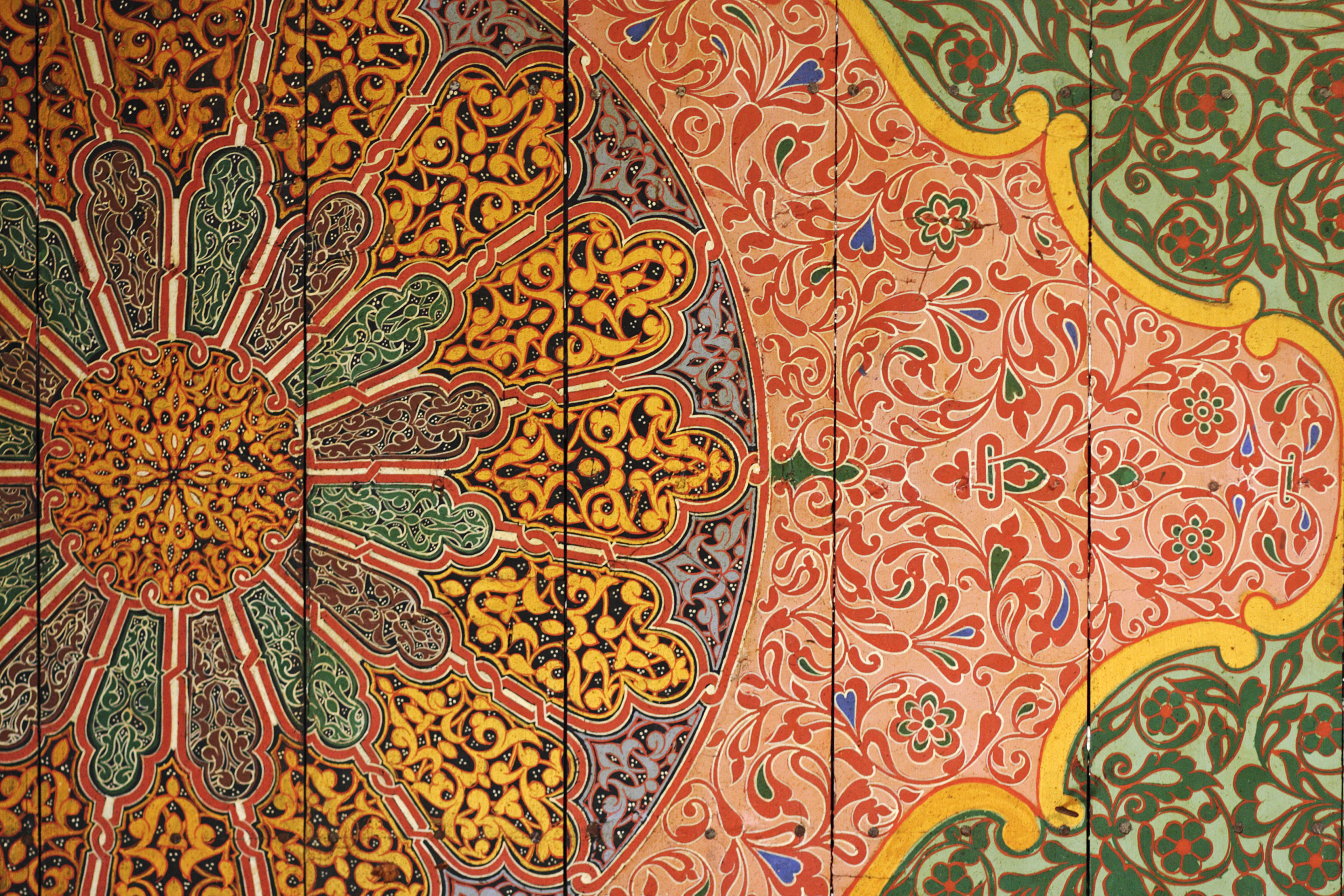 A colourful tiled mural, which appears like a large flower, on the ceiling of the Bahia palace, Marrakesh.